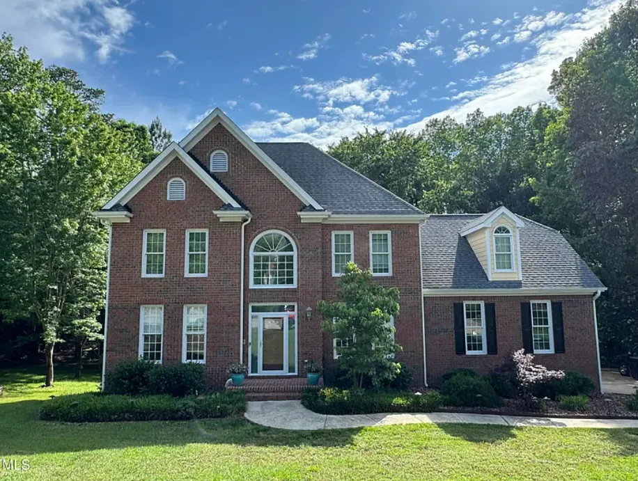 Elegant brick colonial with circular driveway